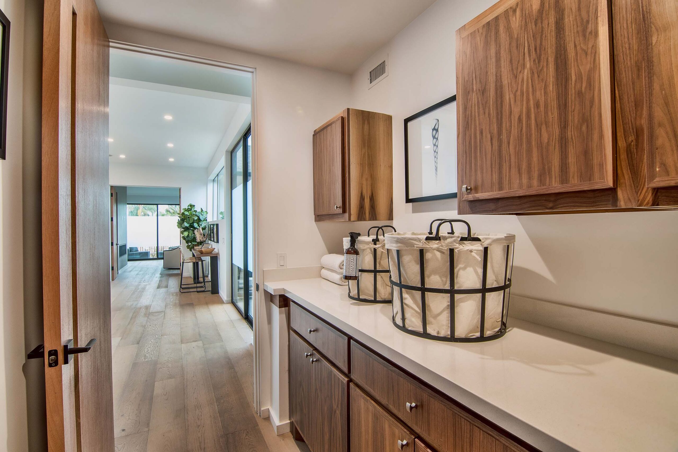 Laundry room with ample storage space in California home