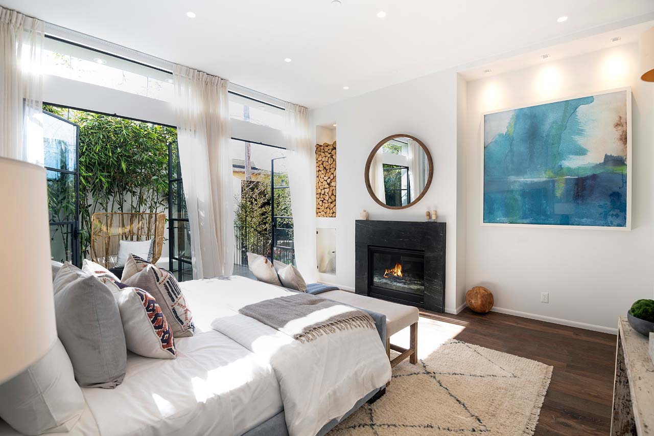 beautiful bedroom with fireplace and outdoor patio