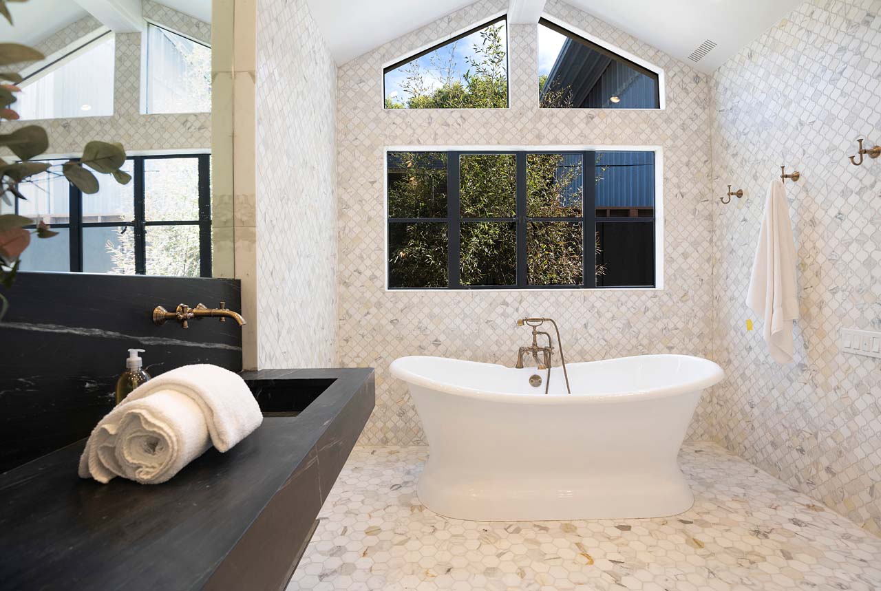 Lavish bathroom with curved standing tub in California home